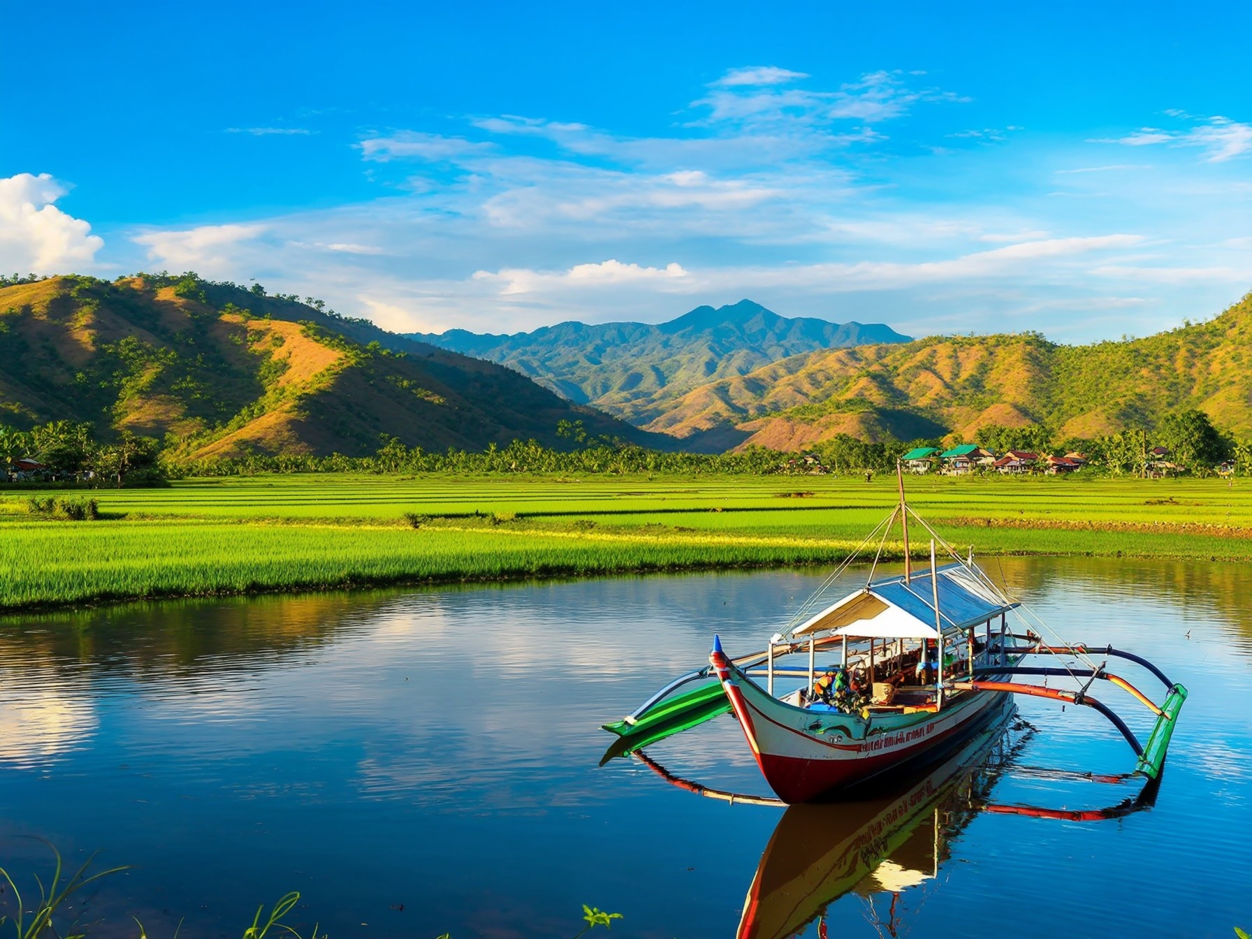 A traditional boat on a serene lake with lush green fields and rolling hills under a clear blue sky.