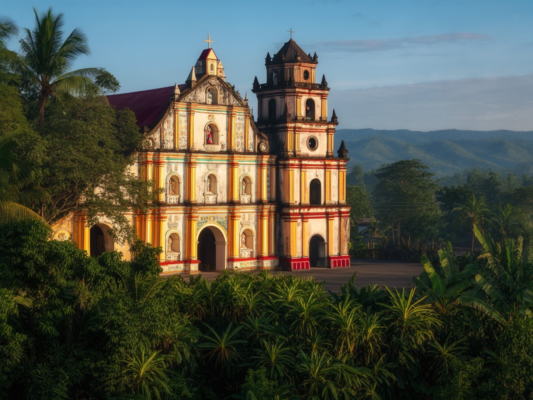 Colonial-style church amidst lush greenery and mountains under a clear blue sky, showcasing vibrant architectural details.